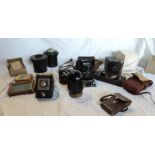 A box containing three vintage cameras and other photographic equipment - various condition