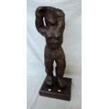 A 30" carved wooden sculpture of a man on plinth base