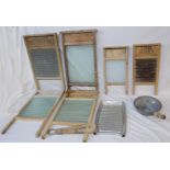 A collection of vintage washboards of various size and style, clothes tongs, pan