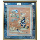 A framed antique Chinese silk panel with bats flying amongst chrysanthemums