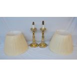 A pair of brass candlestick pattern table lamps with shades
