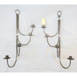 A pair of modern wrought iron four branch wall sconces