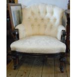 An Aesthetic ebonised and parcel gilt framed button back parlour armchair with ivory coloured damask