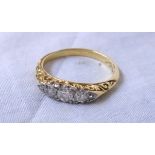 A marked 18ct. yellow metal three stone diamond ring