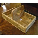 A rustic waxed pine trug with heart pierced handle