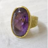 An Italian marked 750 yellow metal ring set with large oval amethyst