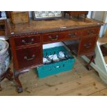 A 3' 9" Victorian mahogany kneehole writing table with remains of tooled leather inset top, three