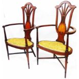 A pair of Edwardian inlaid mahogany framed elbow chairs with large inlaid fan motifs to pierced