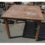 A 3' square slatted teak garden table on standard legs