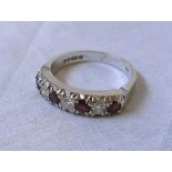 An 18ct. white gold ring, set with four rubies interspersed with three diamonds
