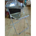 A pair of vintage Pia chrome plated framed and perspex folding chairs