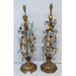 A pair of ornate bedside lamps with enamelled blue flowers, with shades