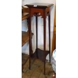 An Edwardian polished rosewood two tier jardinière stand with fret cut decoration and slender square