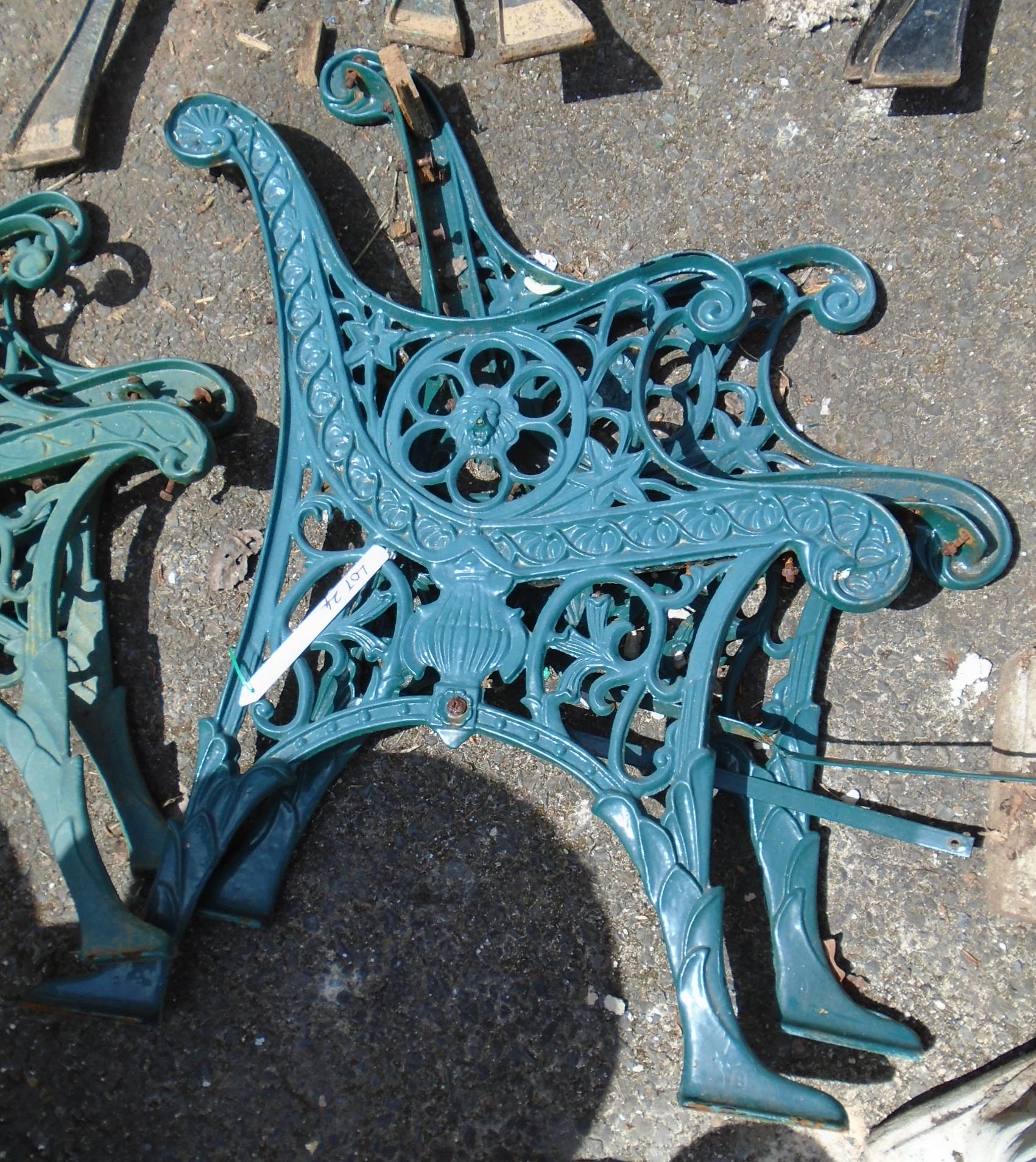 A pair of cast metal bench ends