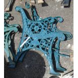 A pair of cast metal bench ends