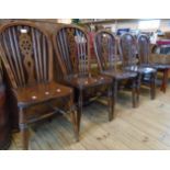 Five matching antique wheelback kitchen chairs with solid elm seats, set on ring turned supports -