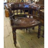 An Edwardian stained wood framed spindle back tub chair with buttoned and studded brown leather