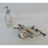 A vintage optic and a miniature soda syphon