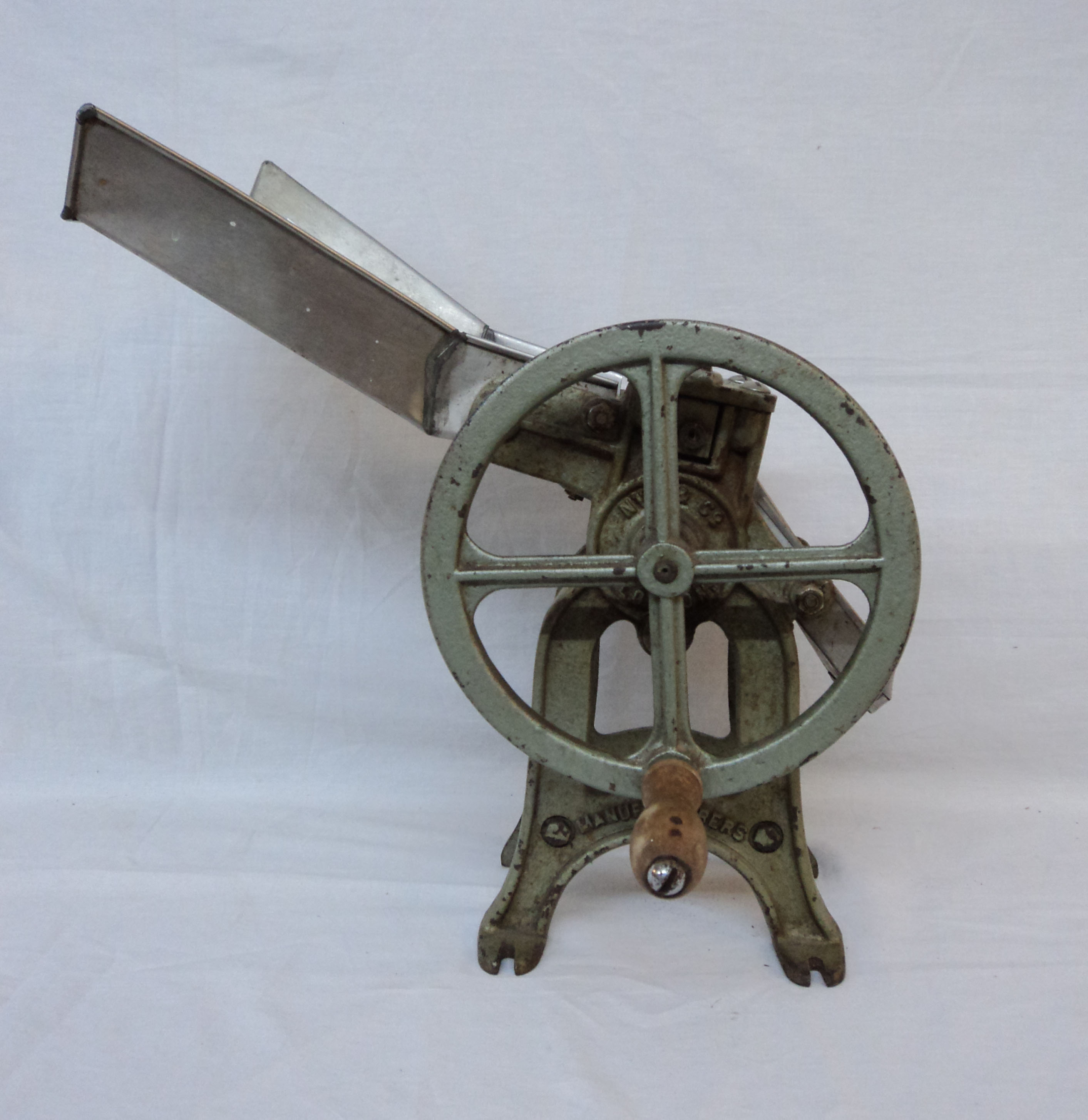 A vintage bean slicer on cast iron bracket