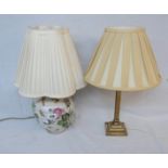 A brass Corinthian column pattern table lamp and a decorative ceramic table lamp - both with shades