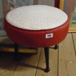 A 1950's Sherborne footstool upholstered in contrasting white and red printed vinyl, set on