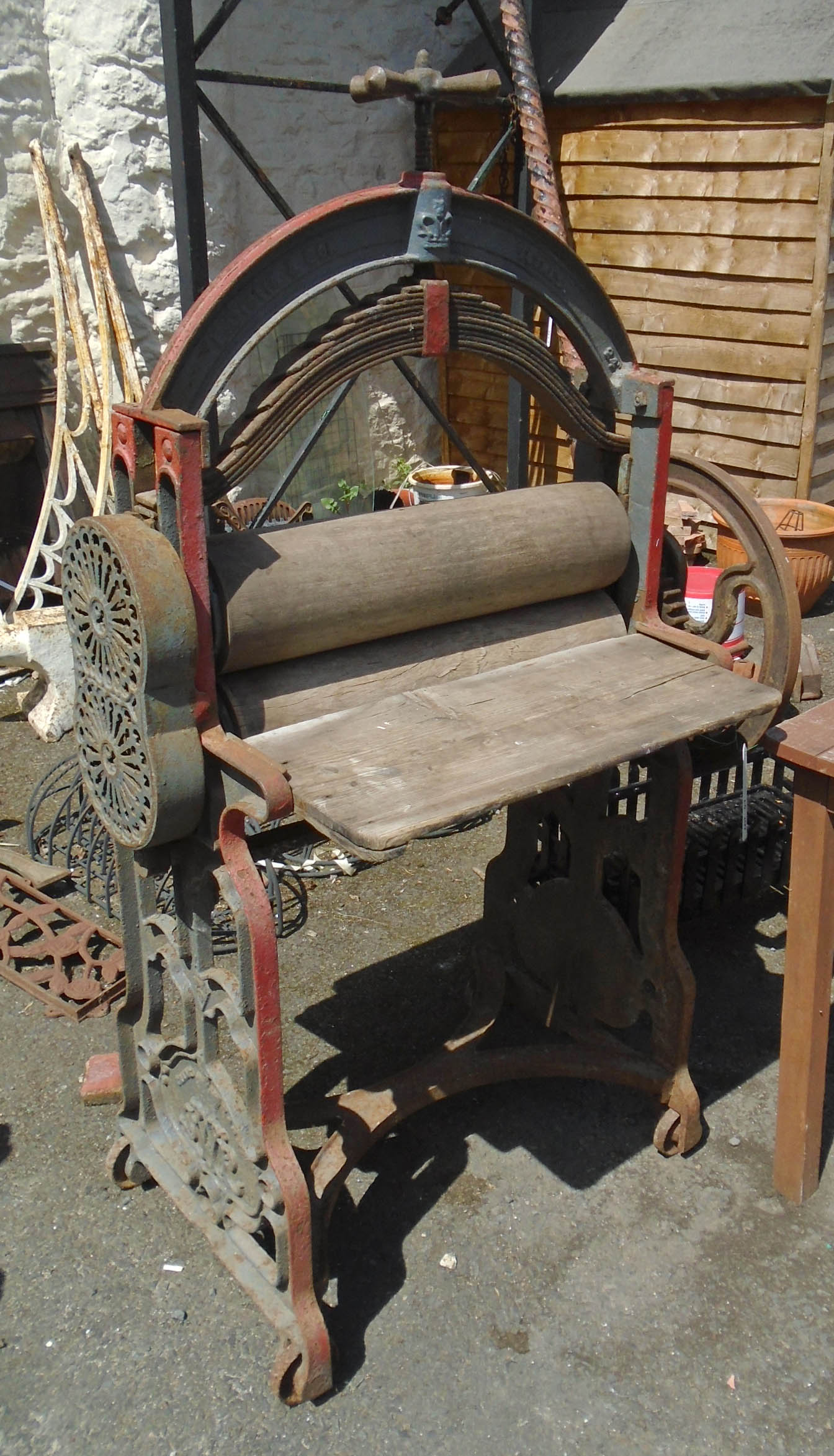 A Victorian cast iron mangle retailed by E. Distin & Son, Totnes with 24" rollers, trays and handle