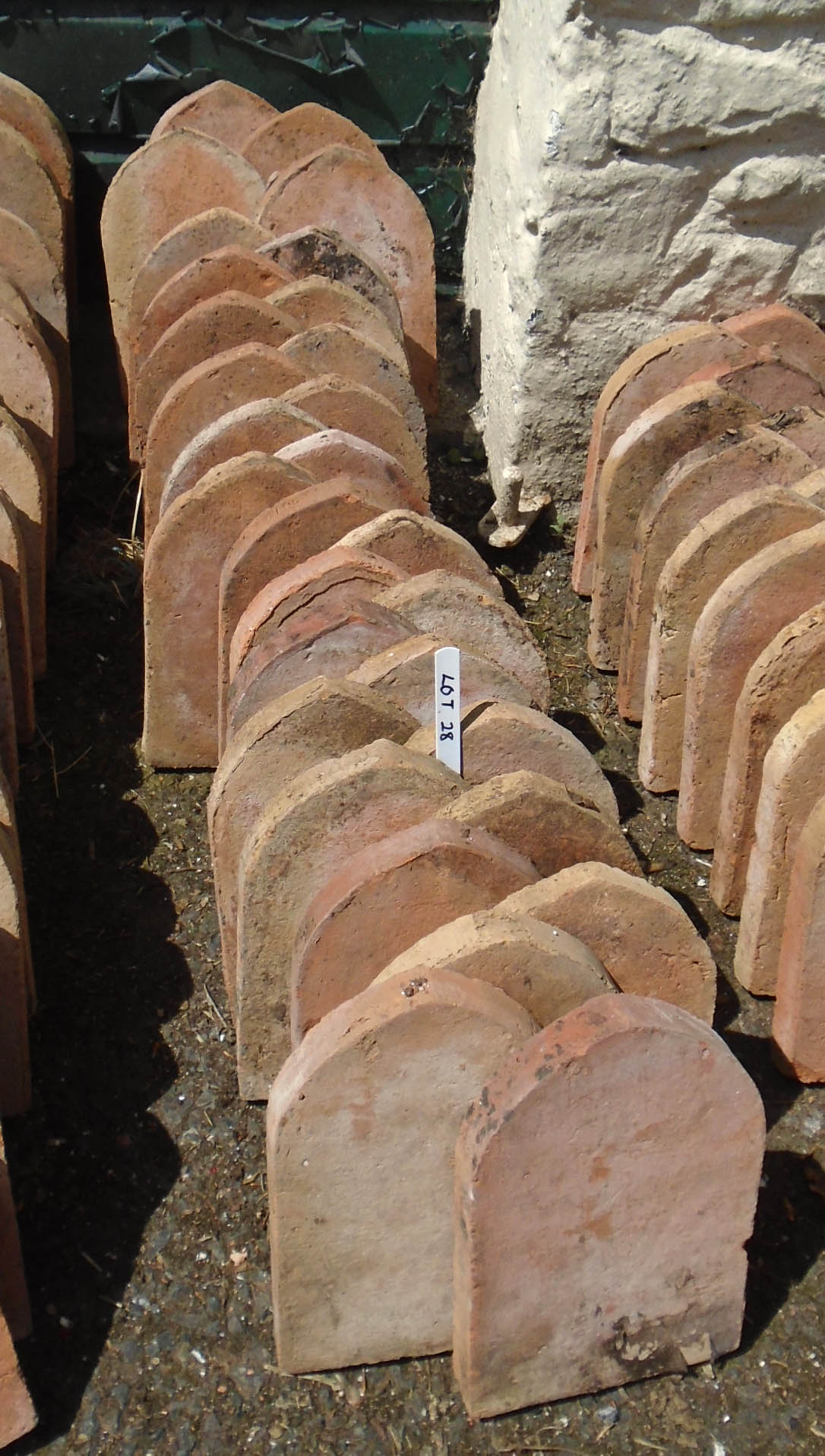 Thirty terracotta mitre top edging tiles