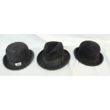 Two black bowler hats and a black Homburg