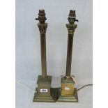 A pair of brass Corinthian column pattern table lamps on stepped bases