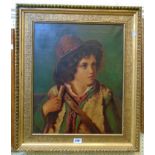 A late 19th Century gilt framed oil on canvas portrait of a continental boy wearing a red hat and