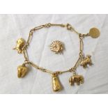 A fine link marked 9ct. and yellow metal charm bracelet