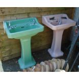 A vintage pink pedestal sink - sold with a green similar