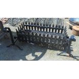 A painted wrought iron dog grate with scroll terminals - to fit 2' 6"
