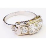 An Art Deco unmarked white metal ring, the stepped setting with raised central diamond two
