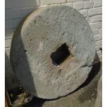 A 2' 10" diameter stone grinding wheel