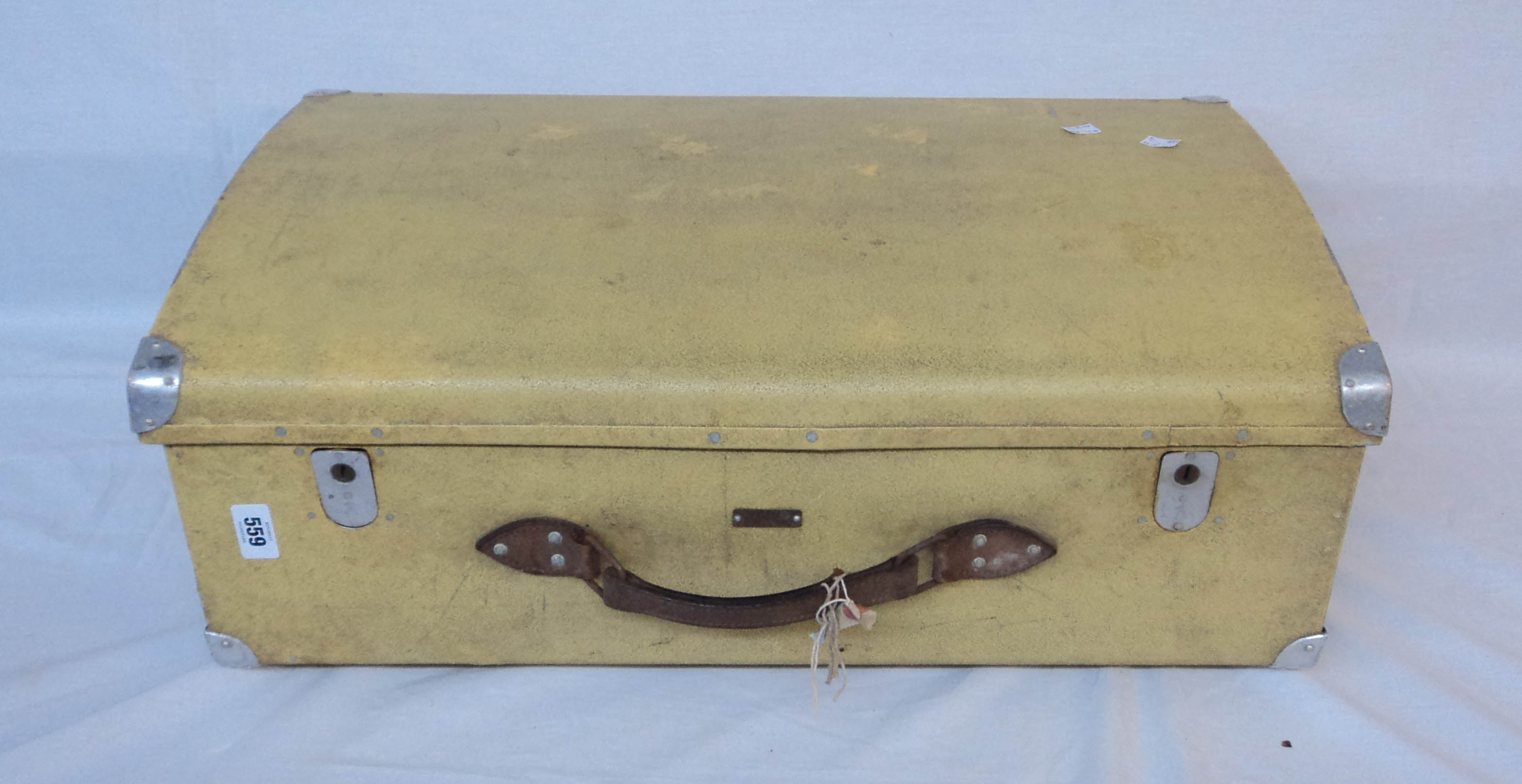 A tin suitcase with pigskin effect finish