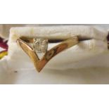 A marked 14k/585 yellow metal gold diamond solitaire wishbone pattern ring
