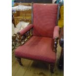 A late Victorian oak framed drawing room armchair with repeat pattern upholstery and flanking