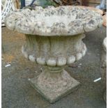 A 22" diameter precast concrete pedestal planter