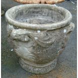 A 17" diameter precast concrete planter with fleur-de-lis decoration