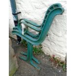 A pair of heavy cast iron bench ends with green painted finish