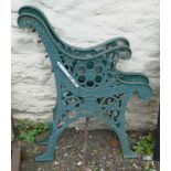 A pair of green painted cast iron bench ends