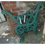 A pair of green painted cast iron bench ends