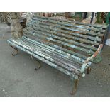 A 6' 6" antique wrought iron and slatted wood garden bench with folding back