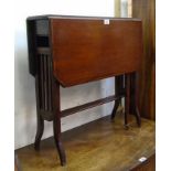 An Edwardian stained walnut and strung Sutherland table with flanking slatted standard ends and