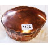 An antique copper oval serpentine box with hinged lid