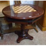 A 33" diameter reproduction mahogany compendium games table with removable leather inset and chess