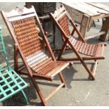 A pair of stained eastern hardwood deck chairs with chain link style seats