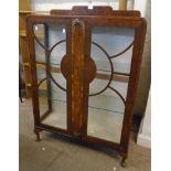 A 34 1/4" 1930's walnut display cabinet with part lined interior and two lined shelves enclosed by a