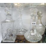 Four cut glass decanters including spirit and ships examples